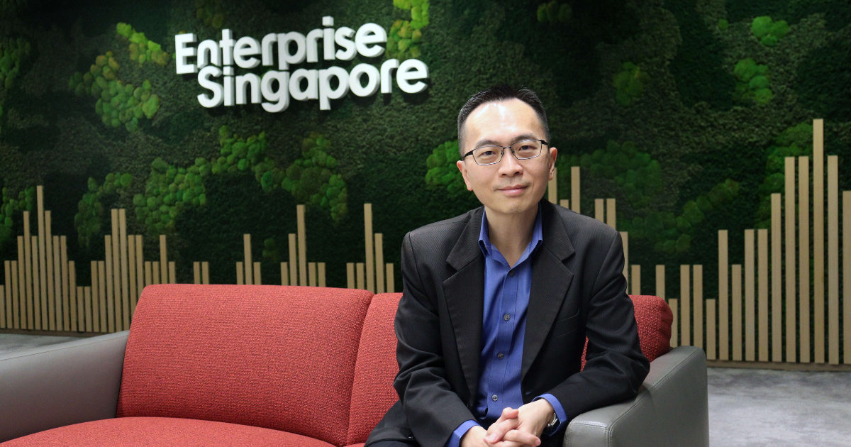 Johnny Teo with EnterpriseSG's logo in the background