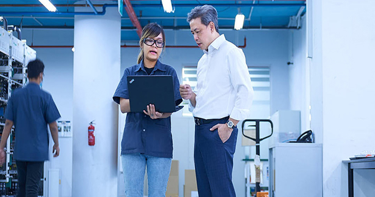 AEM's Chairman Loke Wai San, who is in discussion with Ms Tee Ay Ying from the company's Equipment Systems Solutions department, at its Serangoon North headquarters