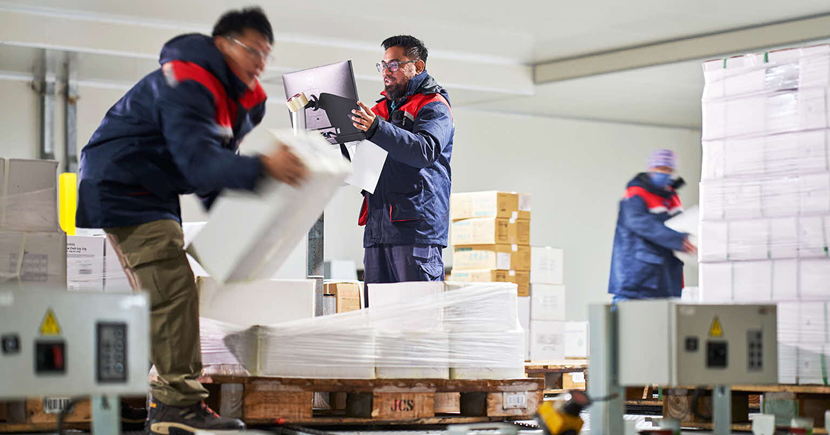 Staff pick and pack goods at the staging area before dispatch