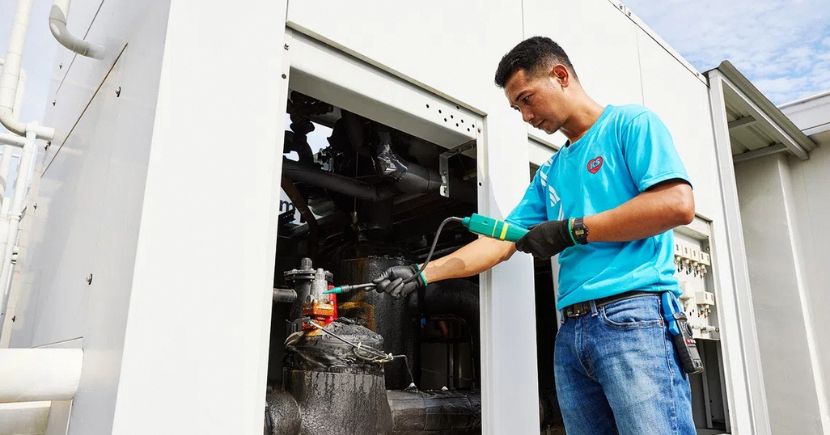 operations staff use a handheld gauge to check for refrigerant leaks from the cold room system