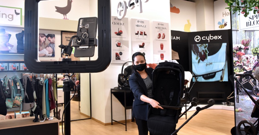 Mothercare staff demonstrating the use of a pram via the Digital Nursery Advisor video call function