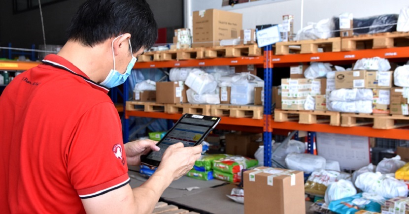 An employee of Pet Lovers Centre using the automated storage and retrieval system