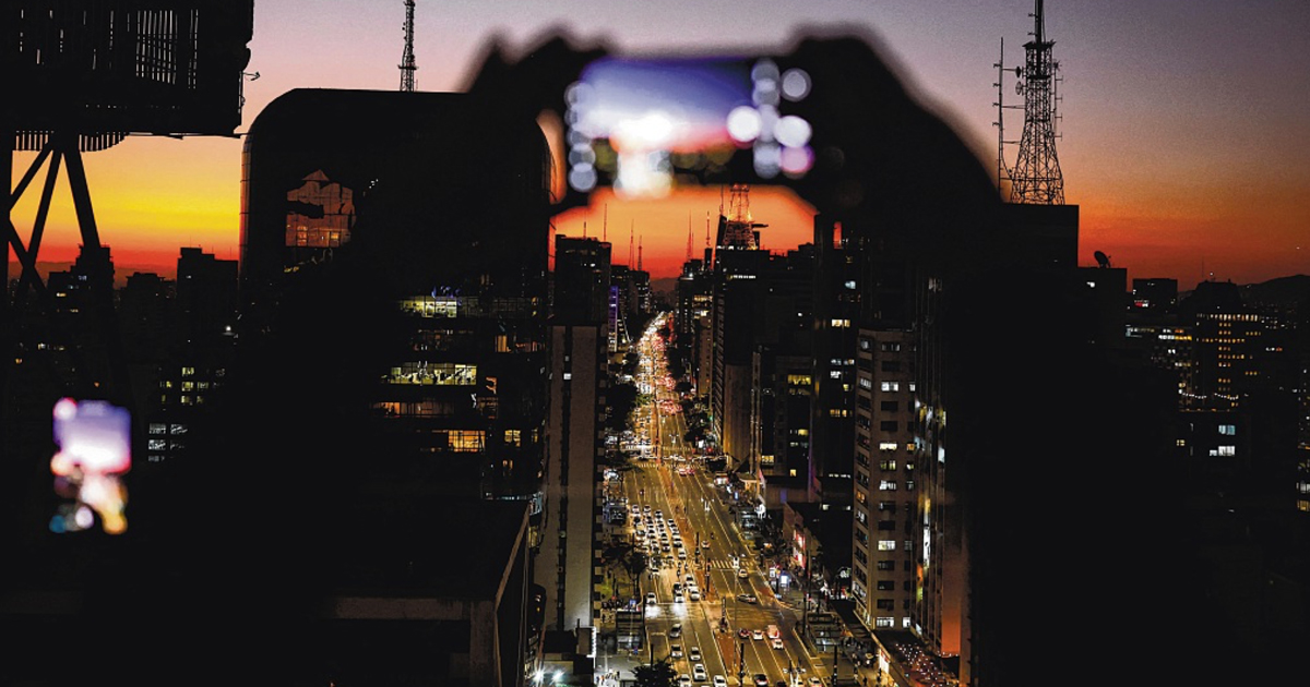 Visitors take photographs at the Mirante do Sesc Avenida Paulista viewpoint in Sao Paulo, Brazil. High mobile penetration rates in South America present opportunities for Singapore companies. PHOTO: REUTERS