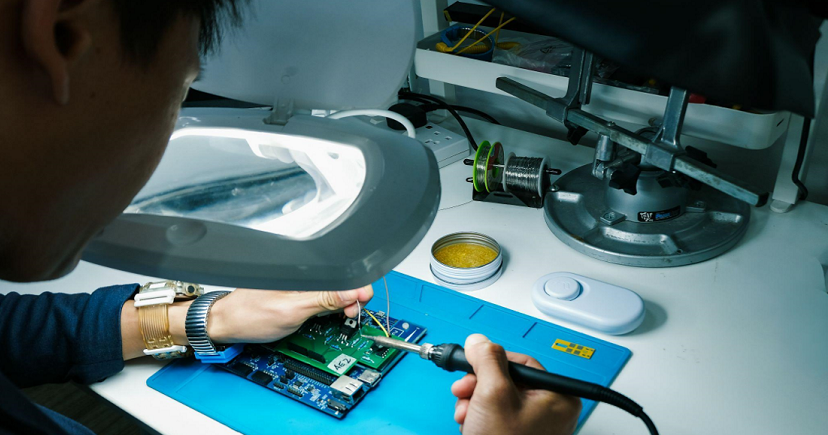 Aevice Health R&D staff soldering components for AeviceMD